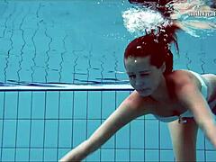 hot brunette flashes tits and shaved pussy underwater at beach