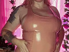 teasing in a latex dress with curvy milf features