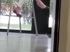 mature woman engages in shoe play with feet and shoes