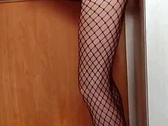 Mature woman in hosiery enjoys anal sex against a wall