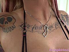 Tattooed dominatrix pegs her black sub