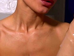 pretty girl slurps on a thick rubber penis