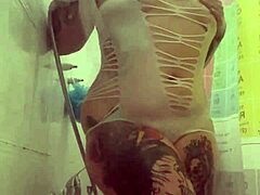 alina feels relaxed in her shower with tattoos.