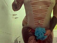 alina feels relaxed in her shower with tattoos.