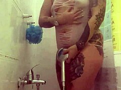 alina feels relaxed in her shower with tattoos.