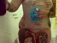 alina feels relaxed in her shower with tattoos.