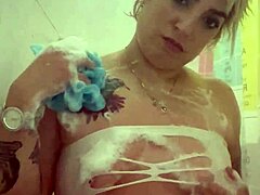 alina feels relaxed in her shower with tattoos.