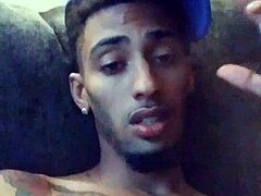 Tattooed woman masturbates suggestively in private scene.