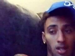 Tattooed woman masturbates suggestively in private scene.