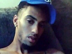 Tattooed woman masturbates suggestively in private scene.