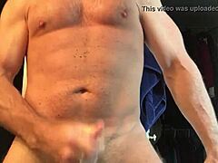 watch this huge muscular bodybuilder have a hard time to cum