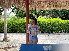 Beautiful babe in a bikini plays beer pong and other fun games in a one on one setting