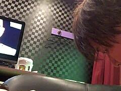 Miyuki tied on hotel sofa with AV playing.