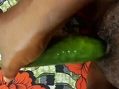 Close up of a black amateur's squirting orgasm during cucumber insertion