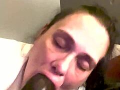 A mature black man gets a blowjob from a small woman