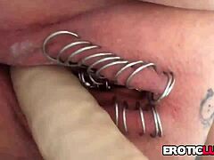 Hot girl with pierced vagina using sex toys for pleasure