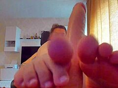 She sucked the big sex toy and gave a footjob with her big tits.