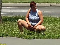 This redhead BBW milf is peeing in public, can you believe it?