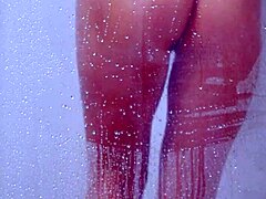 college tanned gorgeous girl feels relaxed taking a shower in her bikini