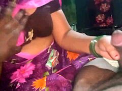 Aunty gives a handjob to her boyfriend's cock in the dorm