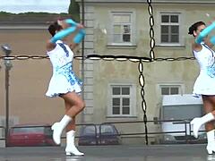 Two nice majorettes performing in their cheerleader outfits