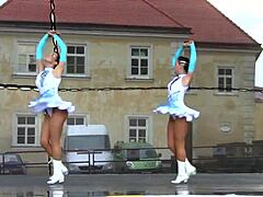 Two nice majorettes performing in their cheerleader outfits