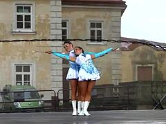 Two nice majorettes performing in their cheerleader outfits