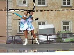 Two nice majorettes performing in their cheerleader outfits
