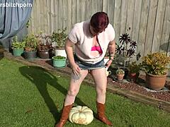Trashy tattooed milf uses huge pumpkin as toilet seat in yard