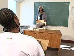 Ebony teacher with glasses in classroom