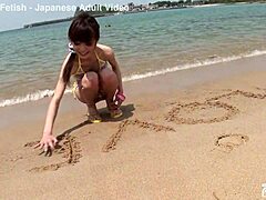 Skinny Japanese Chick In Bikini Teases With Small Tits During Beach Photoshoot Close Up