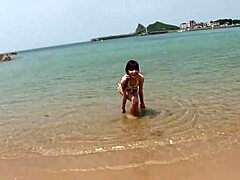 Skinny Japanese Chick In Bikini Teases With Small Tits During Beach Photoshoot Close Up