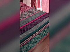 Chubby Colombian housewife with big natural tits gets bent over in bedroom for doggystyle sex, moaning loudly until interrupted.