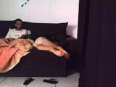 Stepmother shares living room sofa with stepson in cozy family home setting during evening relaxation