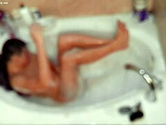 In the bathroom, this boy takes a solo bubble bath, focusing on his feet and bare body in a casual homemade video.