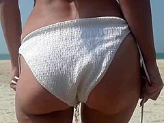 Watch this fat big ass in white bikini peeing openly on public beach!