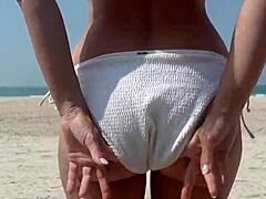 Watch this fat big ass in white bikini peeing openly on public beach!