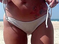 Watch this fat big ass in white bikini peeing openly on public beach!