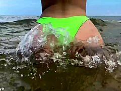 Beach babe spreads ass making playful waves!
