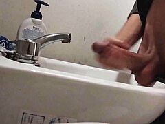 skinny dude rests huge balls on sink preps monster cock for massive cumshot