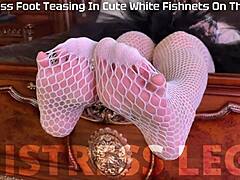 goddess teases sexy feet in white fishnets on bed
