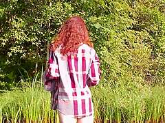 Petite redhead beauty bares natural tits nude lakeside!