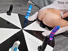 petite teen spins wheel of huge dildos for wild anal orgasm ride