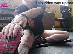 edgy tattooed young gym girl bends into sexy stretches showing off her alternative curves