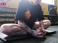 edgy tattooed young gym girl bends into sexy stretches showing off her alternative curves