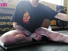 edgy tattooed young gym girl bends into sexy stretches showing off her alternative curves