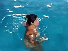 How hot is this redhead flashing nude by the pool?