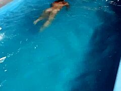 How hot is this redhead flashing nude by the pool?