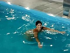 How hot is this redhead flashing nude by the pool?