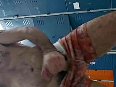 guy strokes huge cock in gym bathroom mirror